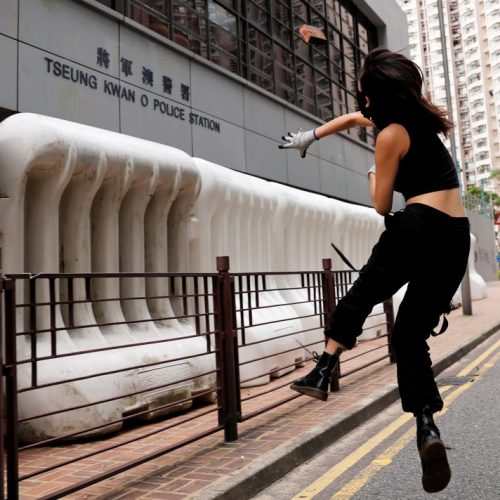 A protester throws a stone at a police station. (Reuters)