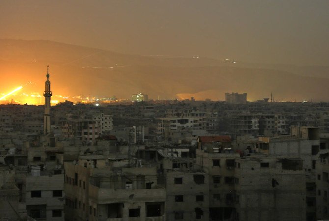 A general view shows smoke and flames rising from buildings following a reported Syrian government missile attack on the rebel-held town of Harasta. (File/AFP)