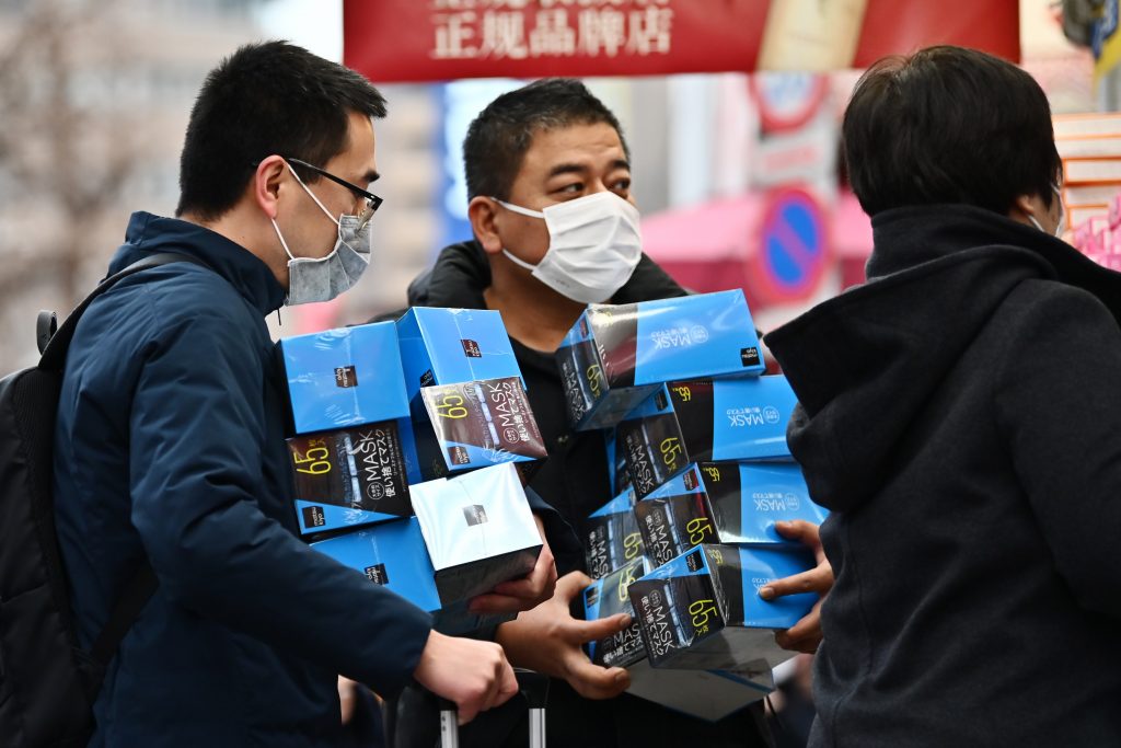 Customers buy face masks from a drugstore in Tokyo's Akihabara area on January 27, 2020. (AFP)