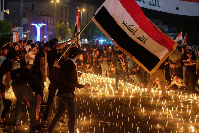 Iraqi protesters hold a candlelight vigil for those killed during anti-government demonstrations in Karbala, south of Baghdad. (AFP)