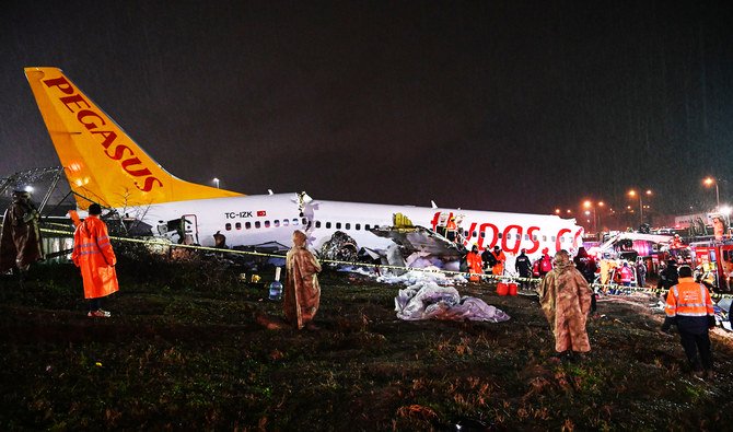Turkish soldiers stand guard as rescuers work at the crash of a Pegasus Airlines Boeing 737 airplane. (AFP)