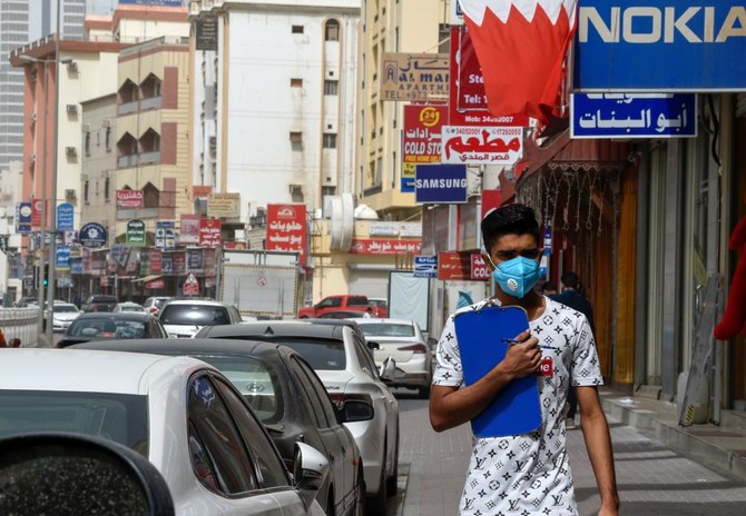 A man wearing a surgical mask is pictured in the heart of the Bahraini capital Manama on February 26, 2020. (AFP)