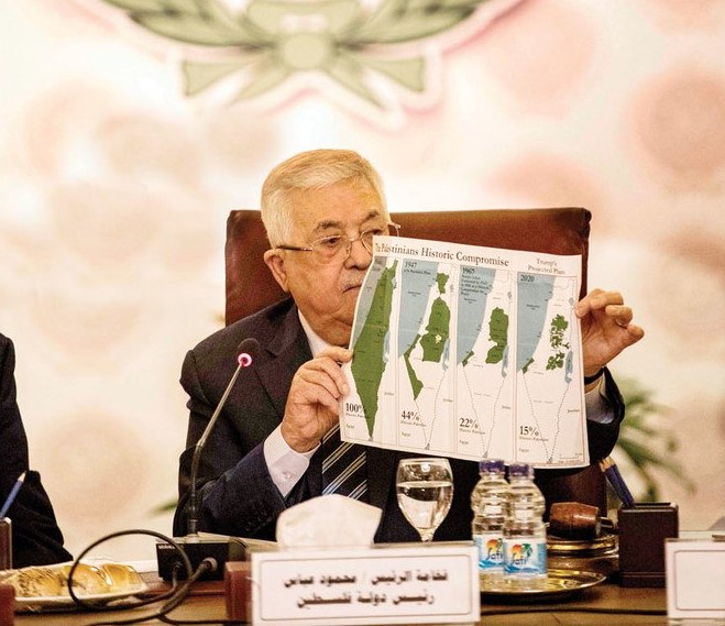 Palestinian President Mahmoud Abbas shows the Arab League meeting maps of, from left, historical Palestine, the 1947 UN partition plan, the 1948-1967 borders between the Palestinian territories and Israel, and the proposed plan for the territories without Israeli-annexed areas and settlements. (AFP)