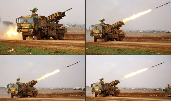 This combination of pictures created on February 14, 2020 shows a Turkish military mobile rocket launcher firing from a position near the village of Miznaz, on the eastern outskirts of Syria's Aleppo province, at Syrian government forces' positions in the countryside of Aleppo. (AFP)
