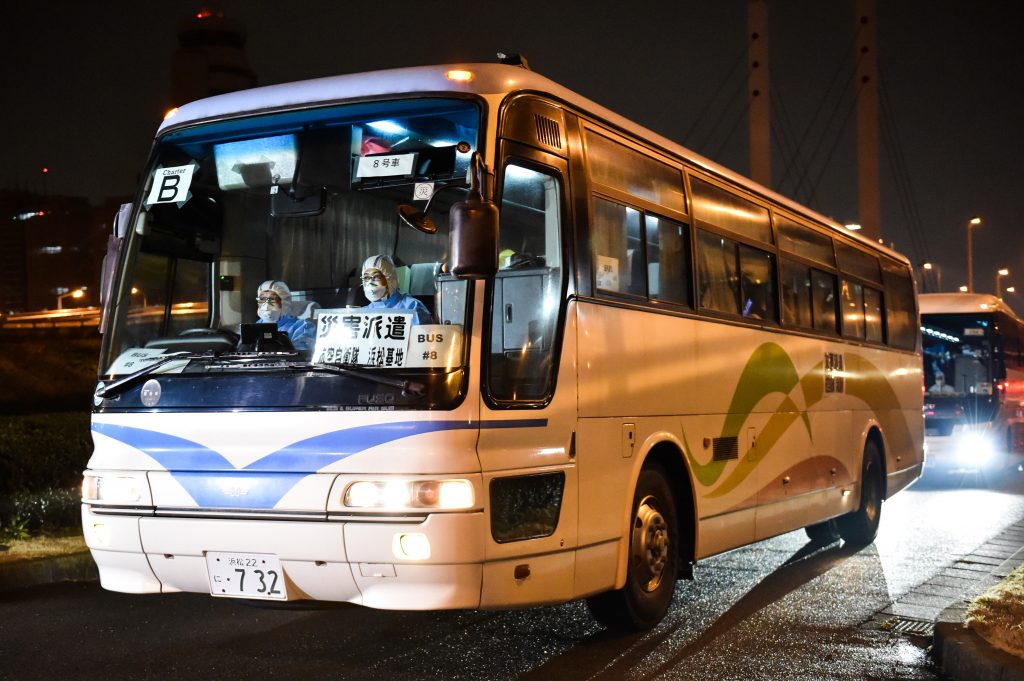 Bus carrying passengers at the Daikoku Pier Cruise Terminal in Yokohama on Feb. 19, 2020. (AFP)