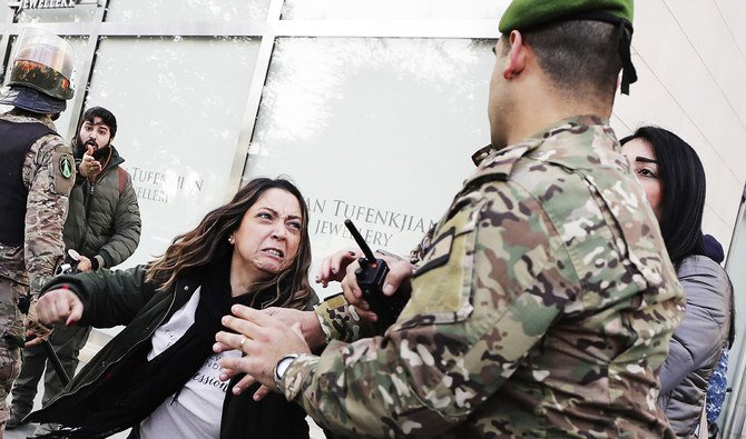 Army soldiers scuffle with anti-government protesters blocking a road leading to the parliament building in downtown Beirut. (AP)