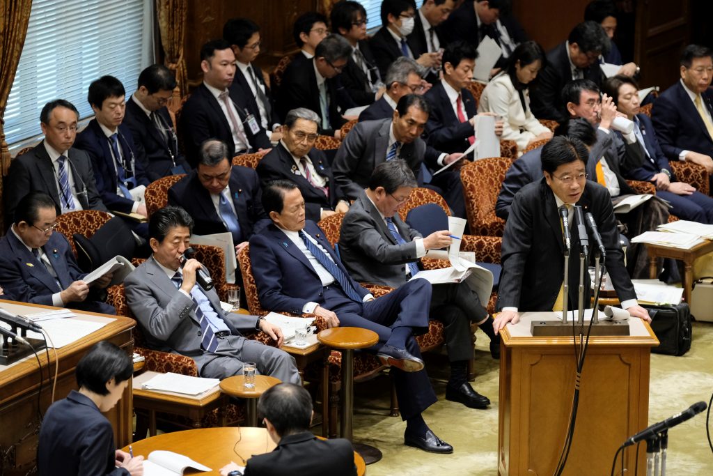 Japan's Health Minister Katsunobu Kato (front, R) speaks during a budget committee session of the upper house at parliament on Jan. 30, 2020. 