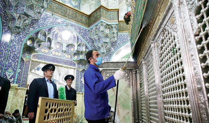 Workers disinfect Qom’s Masumeh shrine, which is visited by a large number of people, to prevent the spread of the coronavirus. (AFP)