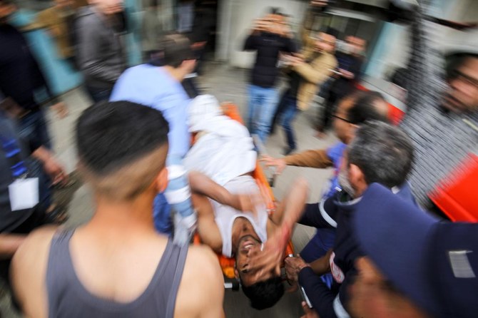 Paramedics treat an injured Palestinian at a hospital in Khan Yunis in the southern Gaza Strip on February 23, 2020. (AFP)