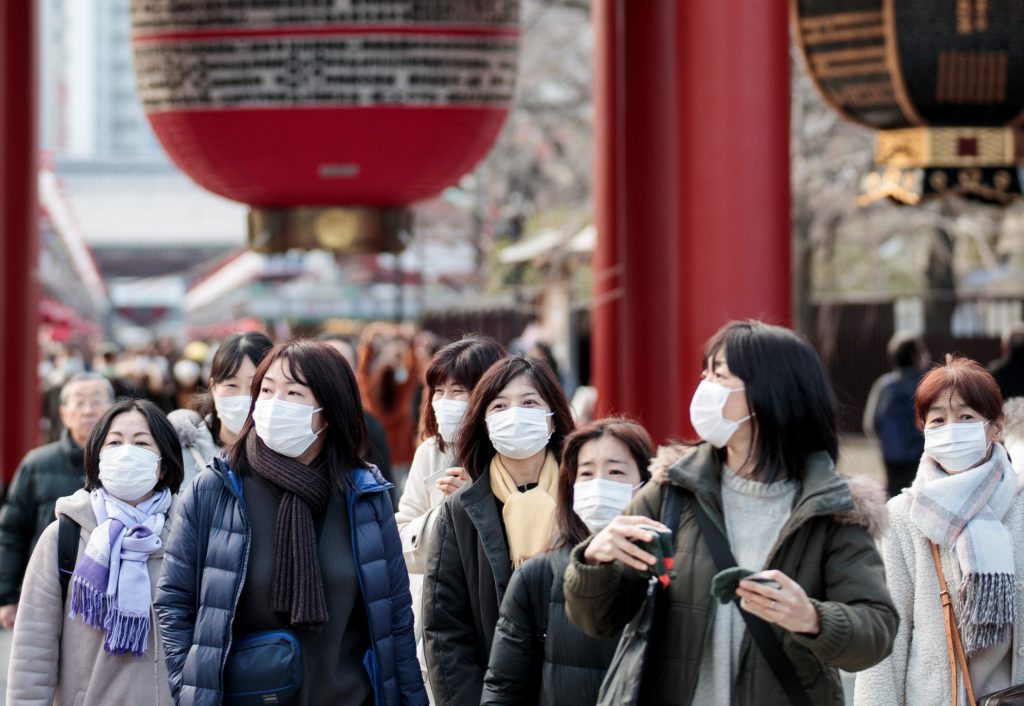 People wear face masks to help prevent the spread of a virus as they visit the Sensoji temple, Tokyo, Feb. 3, 2020. (AFP)
