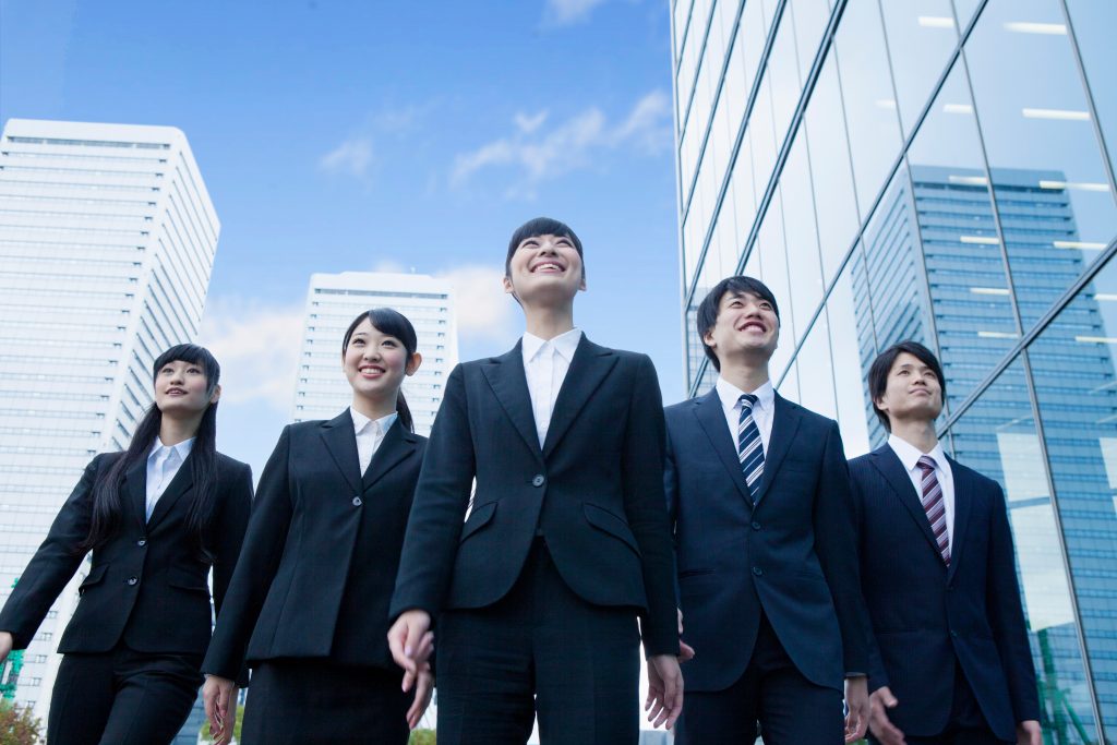 Japanese younger generation in suits. (Shutterstock)