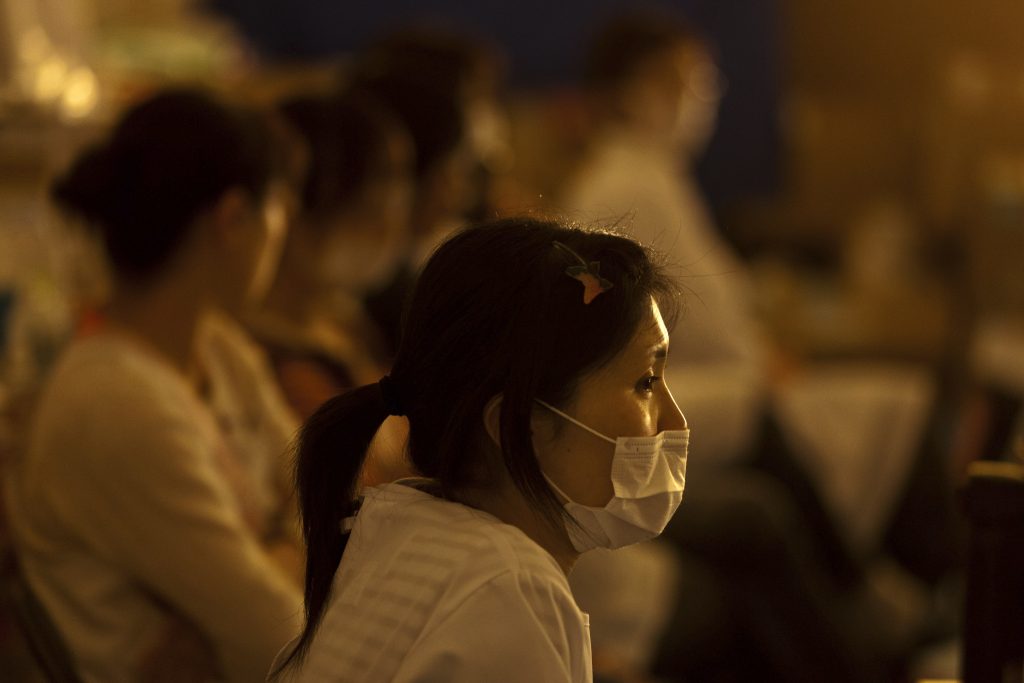 Nurse keeps watch for signs among sleeping evacuees needing care at a medical centre in Ishinomaki, Miyagi prefecture, April. 19, 2011. (AFP)