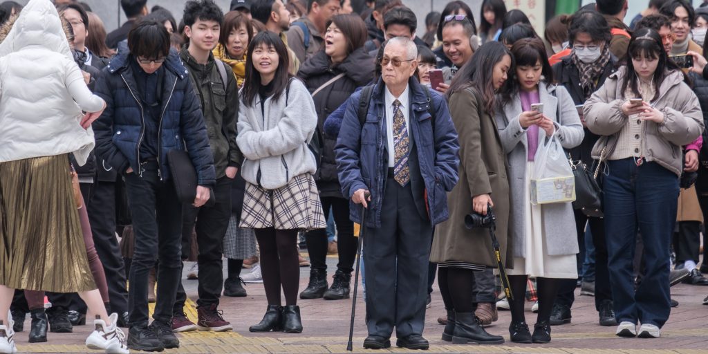 Old man in business suit crossing Shibuya crosswalk, Tokyo, Feb. 27, 2019. (Shutterstock)