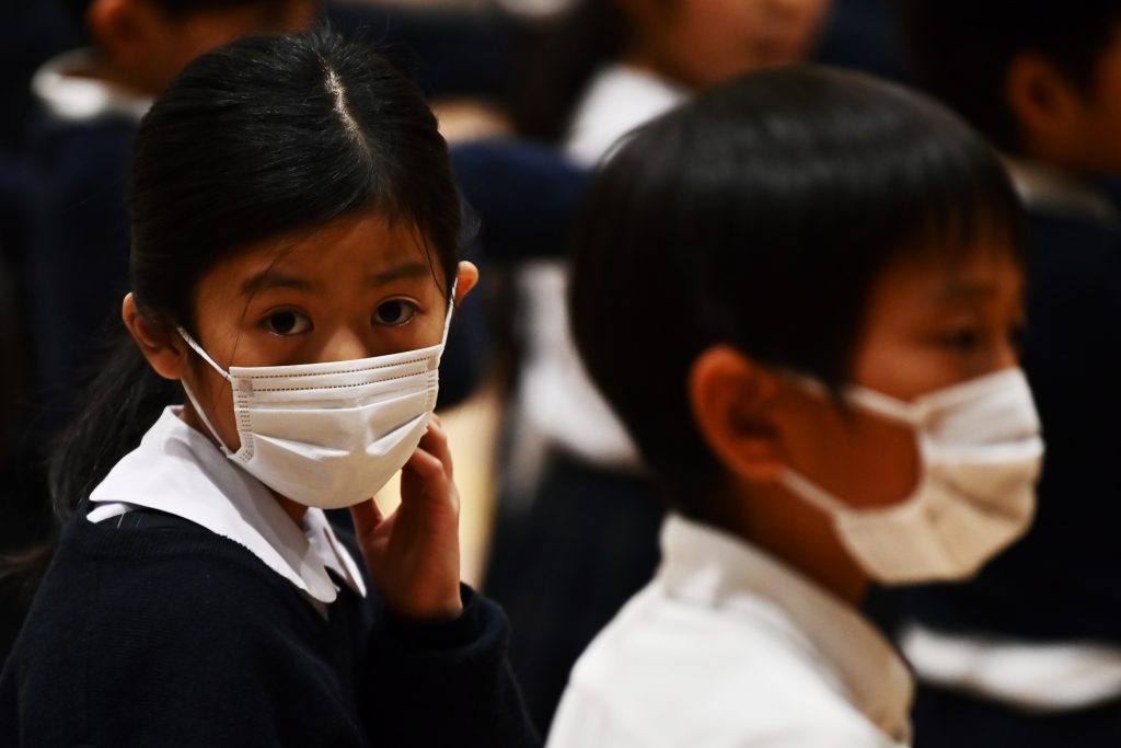 Pupils of the Ariake-nishi Gakuen elementary school wear face masks, Feb. 25, 2020. (AFP)