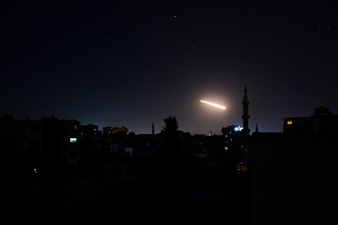 Light in the sky is seen in Damascus, Syria, in this handout released by SANA on Feb. 24, 2020. (SANA/Handout via REUTERS)