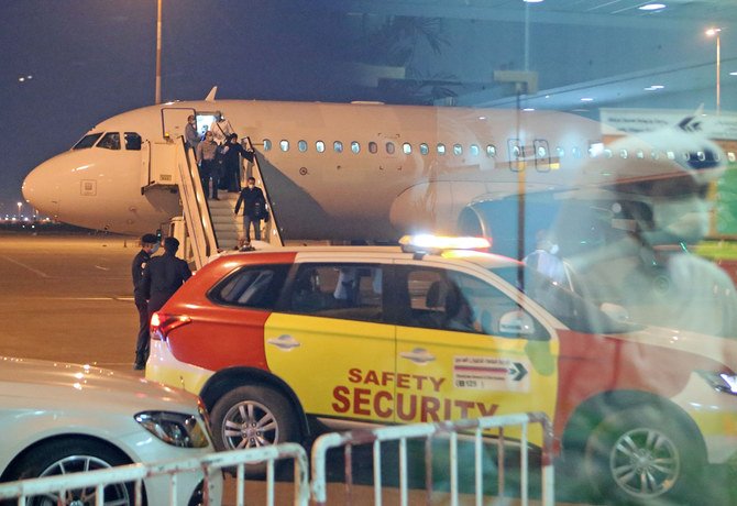 Kuwaitis coming back from Iran disembark at Sheikh Saad Airport in Kuwait City on Feb. 22, 2020, before being taken to a hospital to be tested for coronavirus. (AFP / YASSER AL-ZAYYAT)