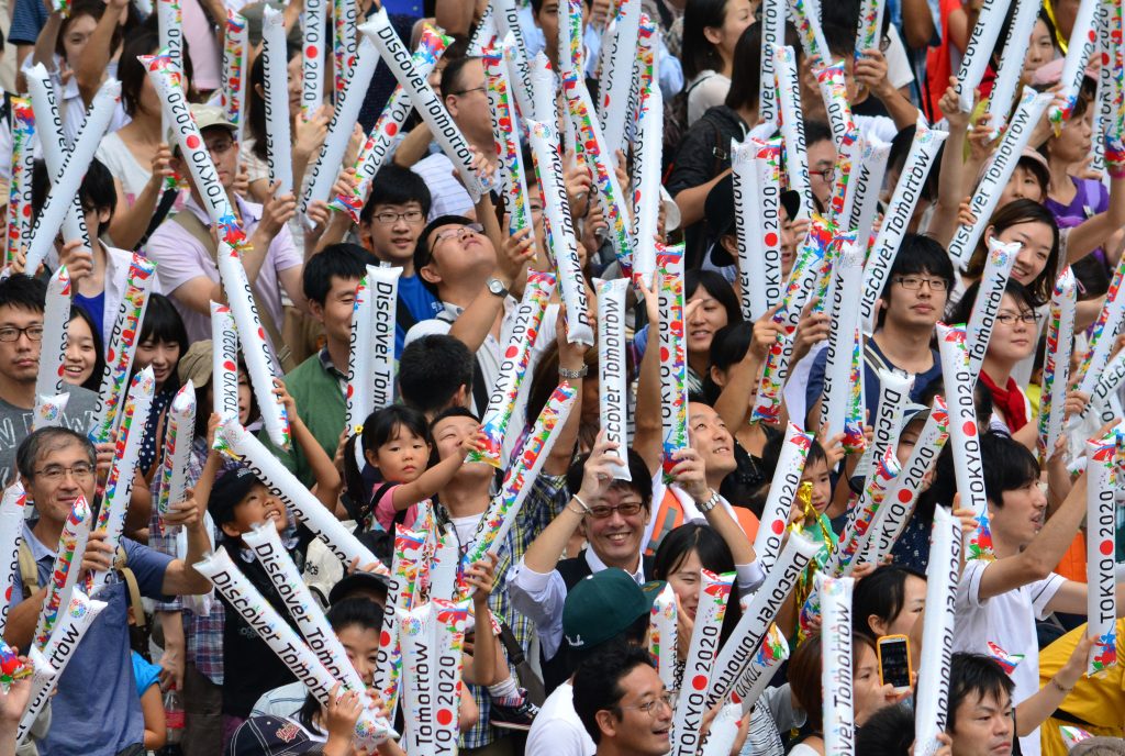 People gathering at the Tokyo metropolitan government building celebrate Tokyo's winning bid to be the host city of the 2020 Olympics on September 8, 2013. 