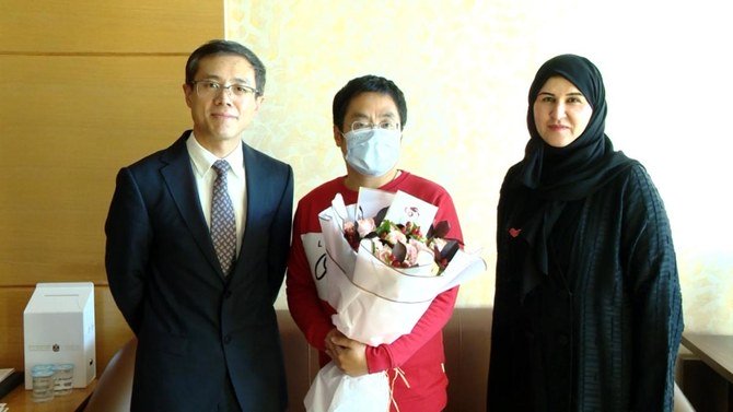 The Consul-General of China to the UAE, Li Xuhang, and Dr. Fatima Al-Attar, head of international health regulations at the health ministry, congratulate the patient on his recovery. (WAM)
