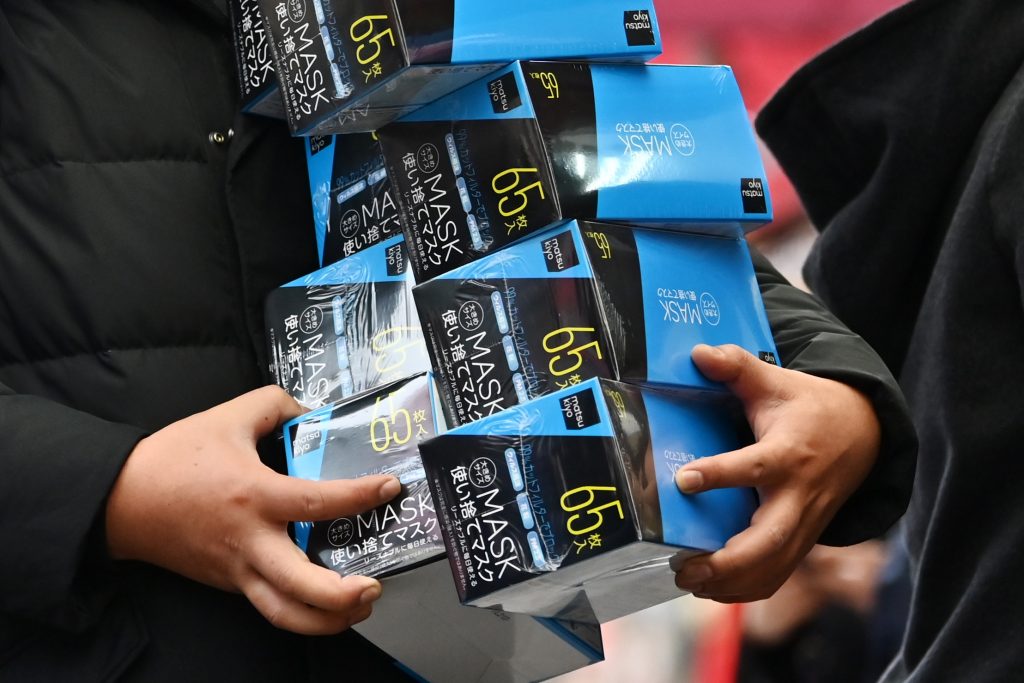 A customer buys face masks from a drugstore in Tokyo's Akihabara area on Jan. 27, 2020. (AFP)