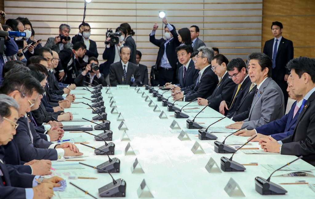 Japan's Prime Minister Shinzo Abe (3R) speaks during a meeting of the headquarters for measures against for the COVID-19 novel coronavirus at the Prime Minister's office in Tokyo, March .18, 2020. (AFP)