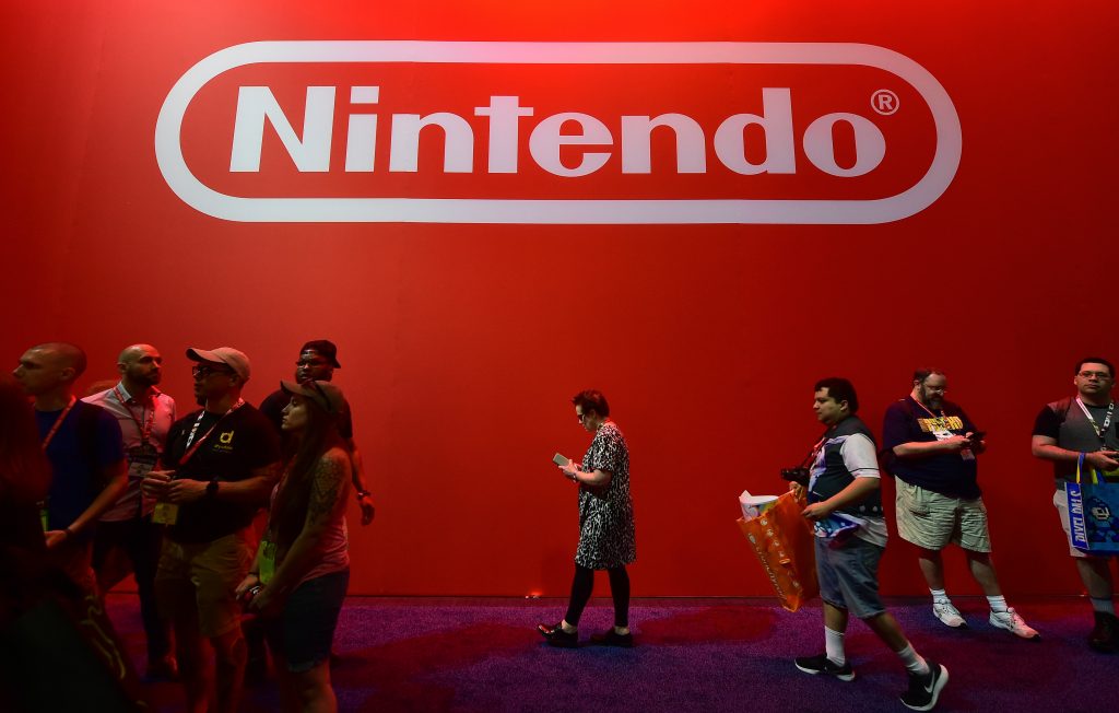 Gaming fans walk past a logo at the Nintendo games section at the Los Angeles Convention Center on day one of E3 2017. (AFP)