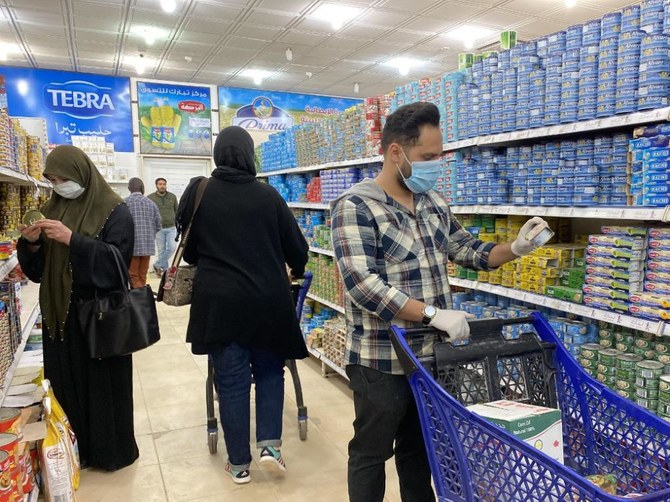 Libyans, wearing protective face masks, shop at a supermarket in the capital Tripoli on March 15, 2020. The war-torn country has reported its first case of the novel coronavirus. (AFP file photo)