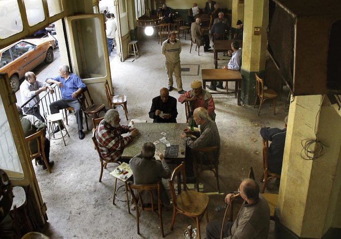 Lebanese men sit at an old cafe in Beirut's Nueiri neighbourhood. (File/AFP/Joseph Eid)
