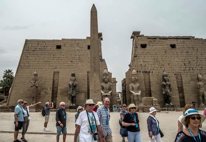 Tourists visit the Luxor Temple in Egypt's southern city of Luxor, on March 11, 2020. Egyptian authorities said that 46 French and US tourists who had been quarantined on a coronavirus-hit Nile cruise boat have flown home. (AFP)