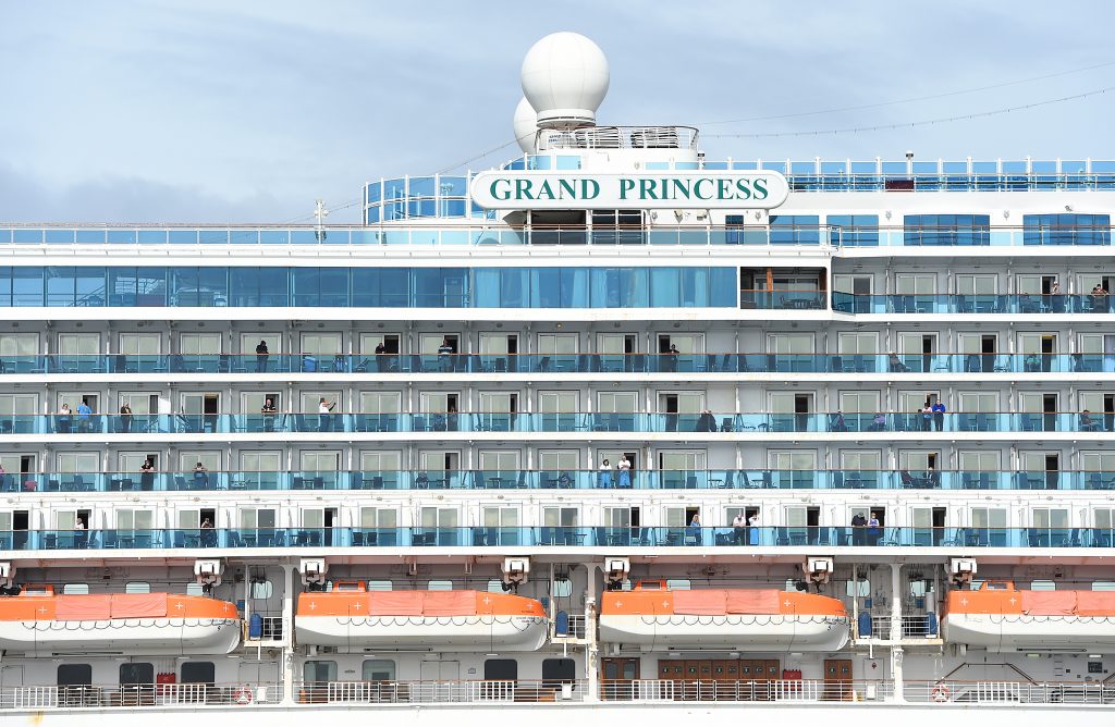 Passengers look out from aboard the Grand Princess cruise ship as it maintains a holding pattern about 25 miles off the coast of San Francisco, California on March. 8, 2020. (AFP)