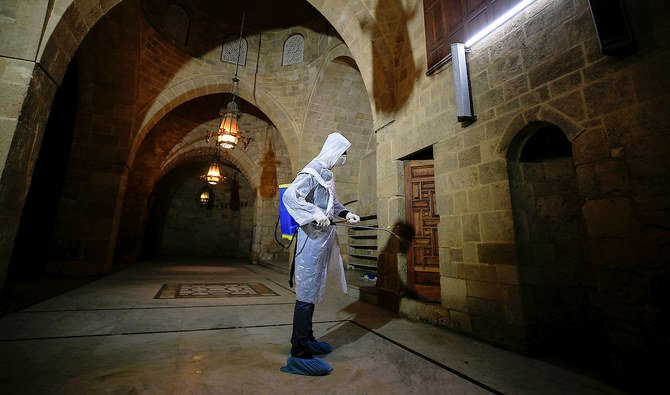 A volunteer sanitizes a mosque, as a precaution against the spread of the coronavirus, in Sidon, Lebanon. (Reuters)