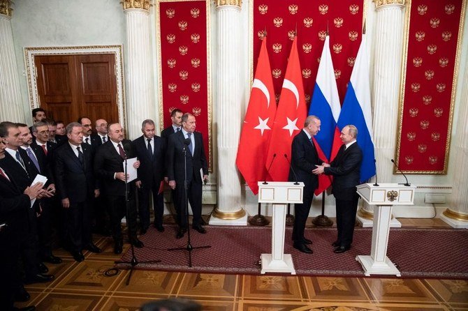 Russian President Vladimir Putin and his Turkish counterpart Recep Tayyip Erdogan shake hands at the end of a joint press statement following their talks at the Kremlin in Moscow on March 5, 2020. (AFP)