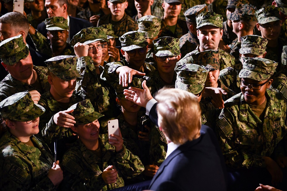 US President Donald Trump greets Marines aboard the amphibious assault ship USS Wasp (LHD 1) during a Memorial Day event in Yokosuka on May 28, 2019. (AFP)