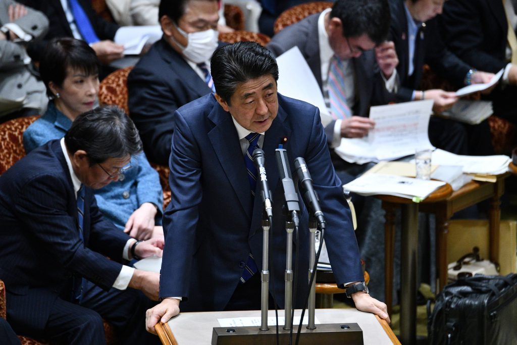Japan's Prime Minister Shinzo Abe (C) answers questions during a upper house budget committee session at parliament in Tokyo on March. 2, 2020. (AFP)