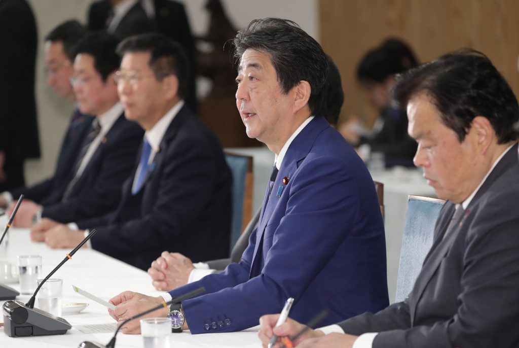 Japan's Prime Minister Shinzo Abe (2nd R) speaks during a meeting between members of the government and the ruling party at office in Tokyo on March 10, 2020. (AFP)
