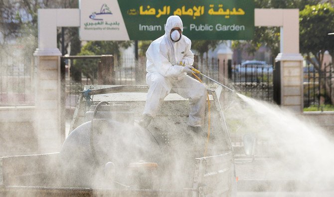 A worker sprays disinfectant. (AP)