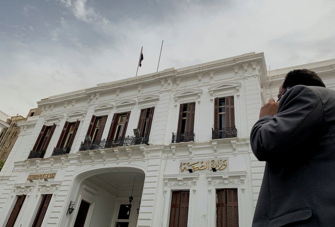 A man uses a mobile phone in front of the Egyptian Ministry of Health following an outbreak of the coronavirus disease (COVID-19), in Cairo, Egypt March 26, 2020. (Reuters)