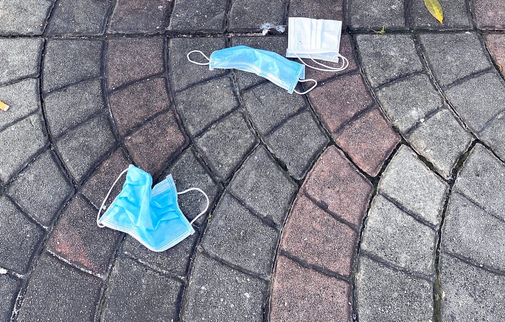 Masks littered onto the pavement, during the outbreak of coronavirus. (Shutterstock)