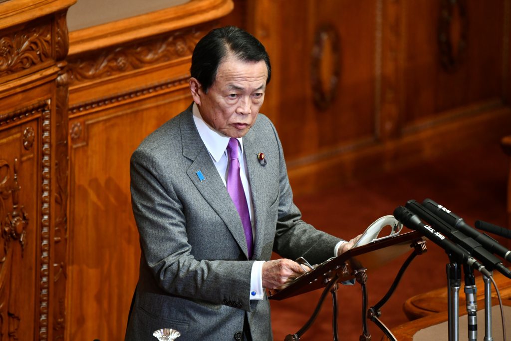 Japan's Finance Minister Taro Aso answers questios during a upper house plenary session at parliament in Tokyo on March 6, 2020.