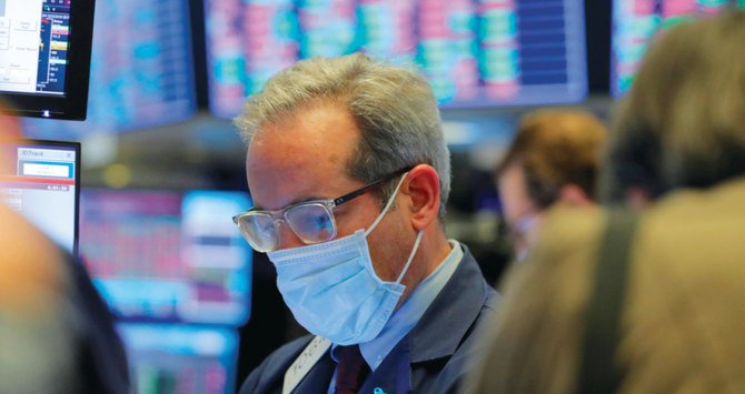 A trader works on the floor of the New York Stock Exchange (NYSE) as the building prepares to close indefinitely due to the coronavirus disease (COVID-19) outbreak. Reuters extent of monetary support from central banks and state budgets, in the fight against the economic damage caused by the COV-19 coronavirus pandemic. (AFP)