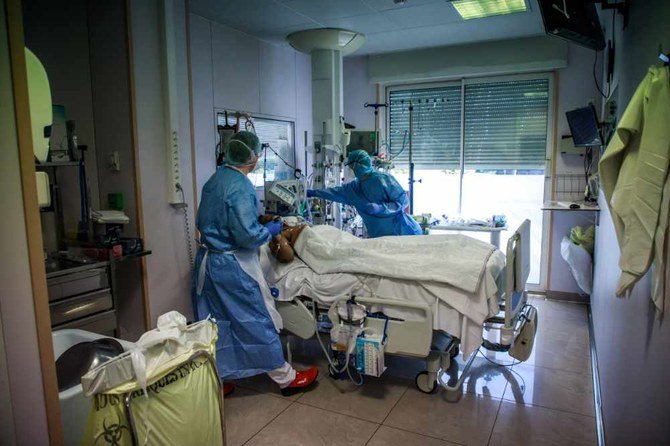 Doctors and nurses of the medical staff take care of a patient at the resuscitation intensive care service of the Ambroise Pare clinic in Neuilly-sur-Seine, near Paris, France, on March 27. 2020. (EPA)