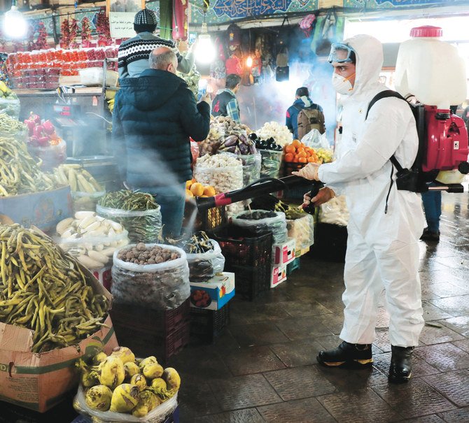 A firefighter disinfects a traditional shopping center to help prevent the spread of the new coronavirus in northern Tehran, which is the worst-hit city in Iran. (AP)