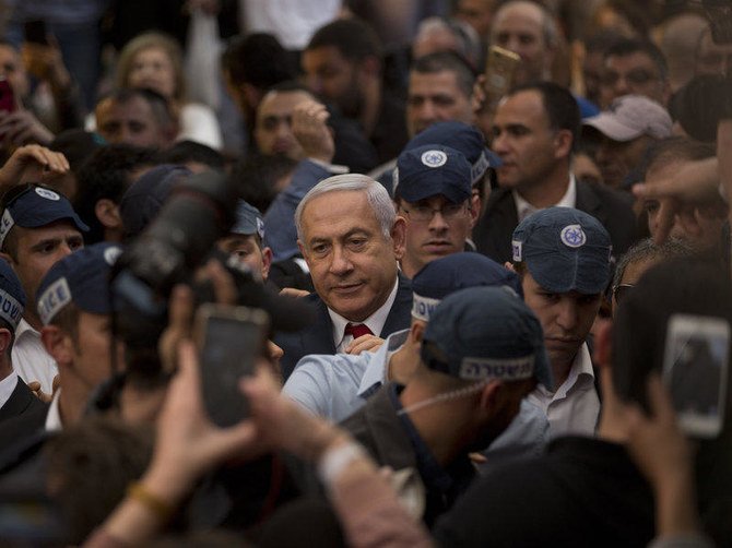 Benjamin Netanyahu is escorted by security guards during a visit to the Hatikva market in Tel Aviv, last year. (AP Photo)