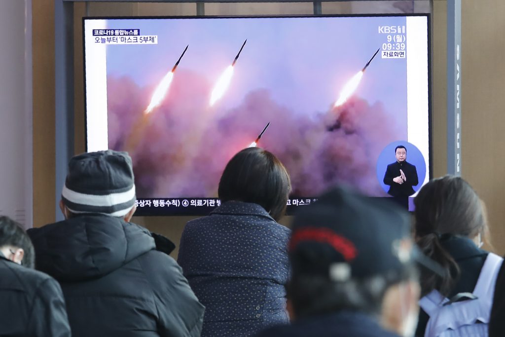 People watch a TV showing file images of North Korea's missile launch during a news program at the Seoul Railway Station in Seoul, South Korea, Monday, March 9, 2020. North Korea fired three unidentified projectiles off its east coast on Monday, South Korea's military said, two days after the North threatened to take 