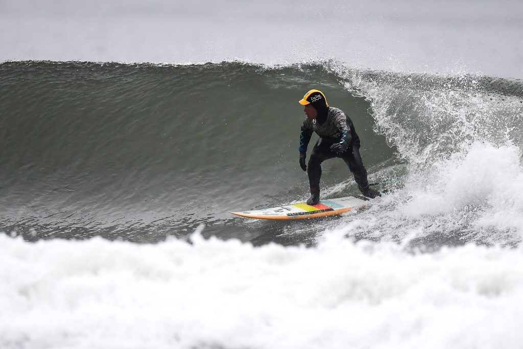 Koji Suzuki, a surfer and a surf shop owner, riding a wave in Minamisoma, Fukushima prefecture. (file photo/AFP)