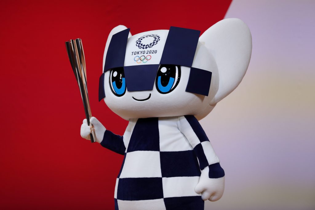Miraitowa, mascot for the Tokyo 2020 Olympic Games, holds an Olympic torch during a ceremony marking one year before the start of the games in Tokyo. (file photo/AFP)
