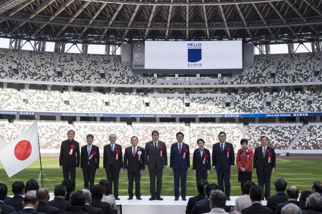 The Tokyo 2020 Olympics organizers celebrating the completion of the main stadium featuring Japanese tradition of using woods, three years after construction work started. (AFP)