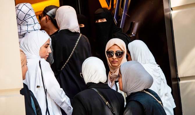 Women from Saudi Arabia and Asia, queue outside a luxury brand Louis Vuitton store in Istanbul on August 13, 2018. (AFP)