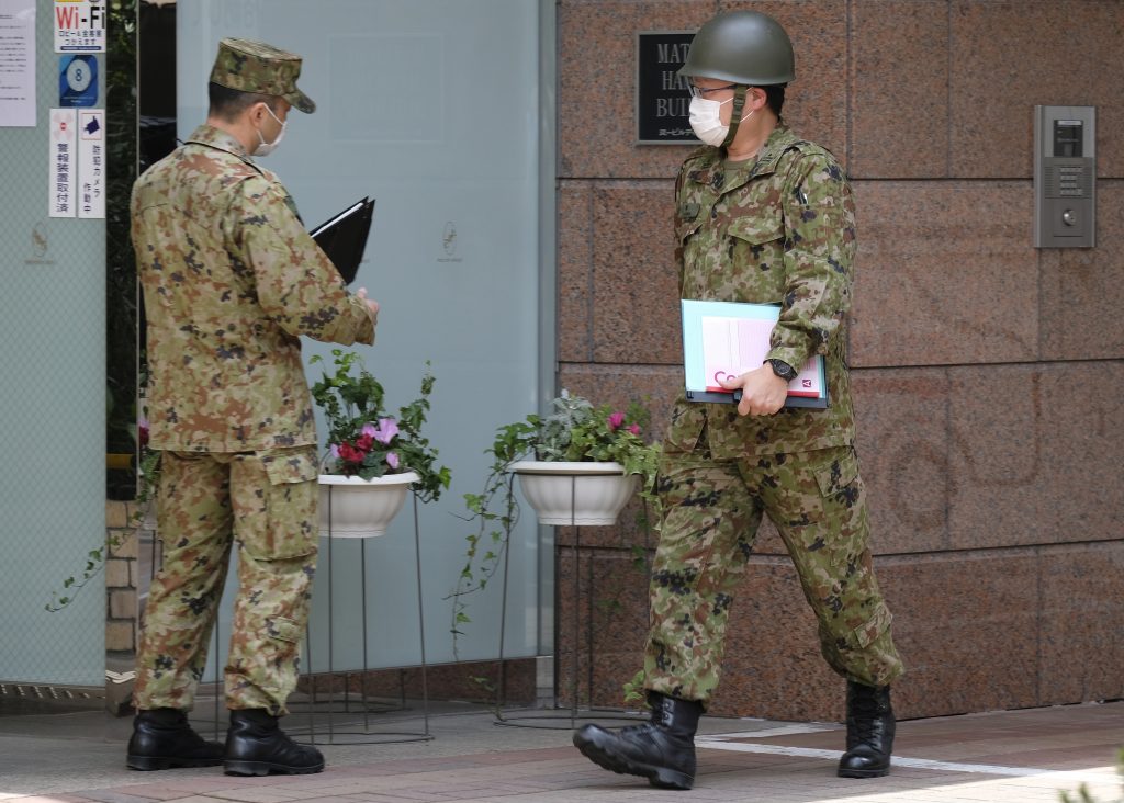 During the missions, SDF officers instructed local officials on how to put on and take off medical gowns, caps and gloves while preventing infections. (AFP)