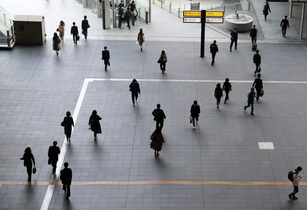 Passengers walk at JR Osaka Station on the first day of a state of emergency due to the COVID-19 coronavirus outbreak in Osaka on April. 8, 2020. (AFP)