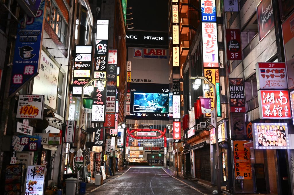 A general view shows the usually popular and crowded entertainment area of Kabukicho during a Saturday night in Tokyo's Shinjuku area on April. 11, 2020. (AFP)